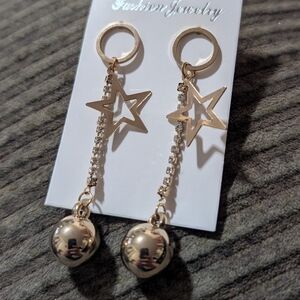 Dangle/drop earrings with a star motif connected by a chain to a round, polished